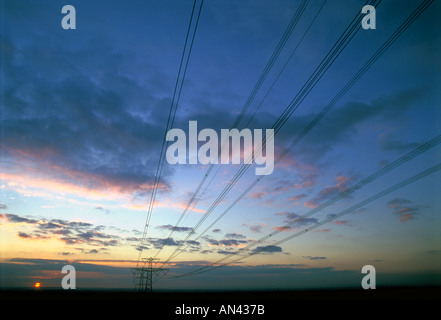The sun setting behind an electricity pylon near Bristol England Stock Photo