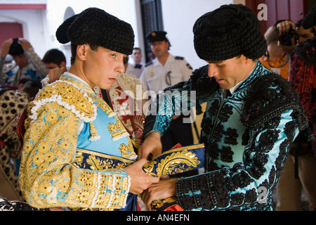 Bullfighter being helped by his assistants to get dressed for the paseillo or initial parade. Stock Photo