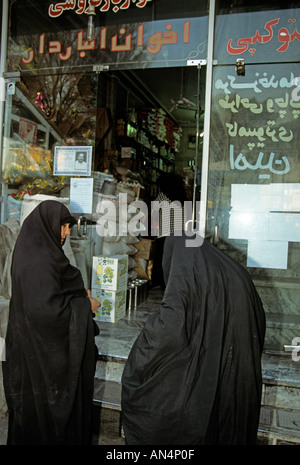 Two women in burqas shop for brooms near Mandawi Market in Kabul Stock Photo - Alamy