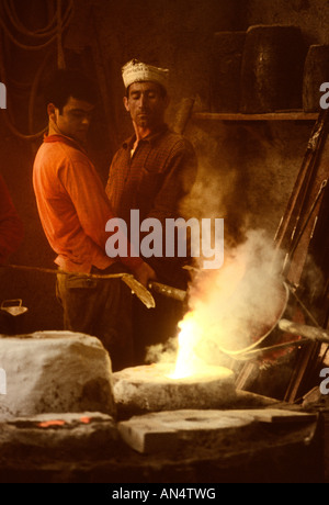 Men pouring bronze at a foundry in Rome, Italy Stock Photo