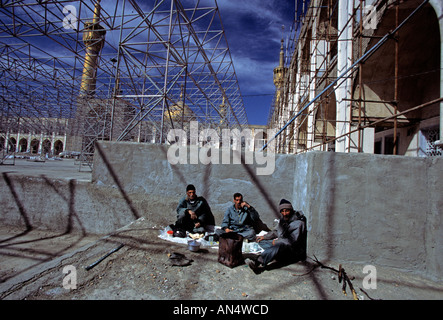 Workers take a break during the restoration of the Khomeini mosque in Tehran Iran Stock Photo