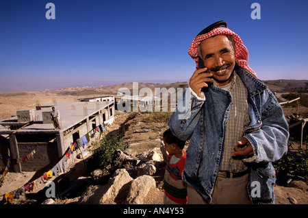 Bedouin man using mobile phone at encampment, Jerusalem Stock Photo