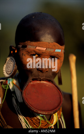 A young Surma woman wearing the traditional clay plate in her lower lip. her face is traditionaly decorated. Stock Photo