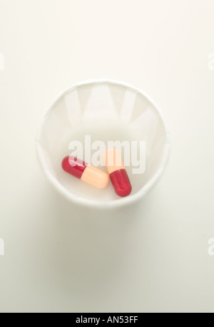 Medical capsules in a cup Stock Photo