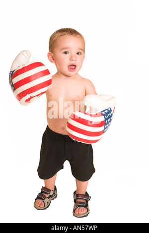 Todler standing with big boxing gloves Stock Photo