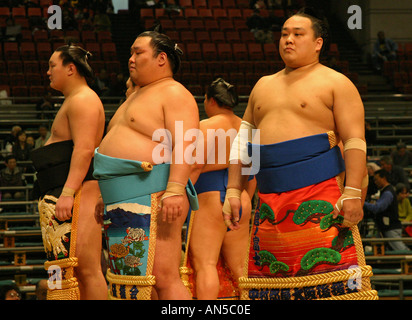 Sumo wrestlers in ceremonial stable dress attend the pre fight ceremony at the spring Sumo tournament in Osaka Japan Asian sport Stock Photo