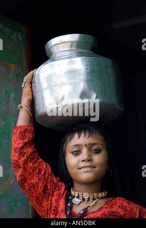 Portrait of a Rajasthani girl carrying a waterpot on her head, Rajasthan (India) Stock Photo
