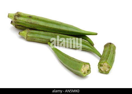 Okra ladies fingers or bindi on white background with one cut to show seeds inside Stock Photo