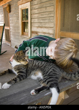 boy with cat on front porch Marjorie Kinnan Rawlings Historic State Park Cross Creek Florida history public land cracker house Stock Photo