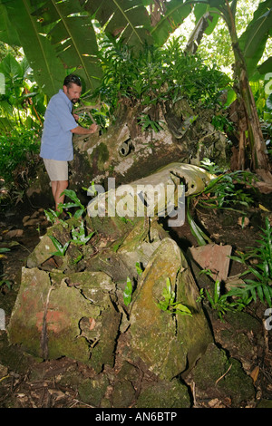 Visitor inspects remains of Japanese Zero fighter plane on Peleliu one of the bloodiest battles of the Pacific in WWII Stock Photo