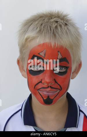 Halloween party - young blond haired boy with face pained as the devil Stock Photo