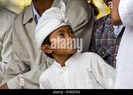 Young Boy during Odalan Ceremony at Pura Basukian or Besakih Puseh Jagat Hindu Temple Bali Indonesia Stock Photo