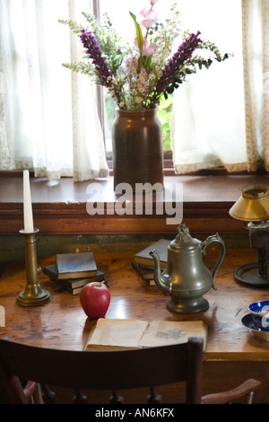 ILLINOIS Galena Dowling House oldest house in Galena built 1826 pewter coffee pot candlesticks and knick knacks on wooden desk Stock Photo