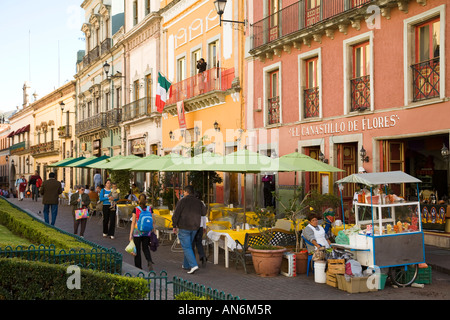 MEXICO Guanajuato Restaurants and street vendors along Plaza de la Paz tables and umbrellas people walking Stock Photo