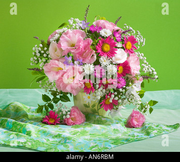 Studio arranged colorful banch bouquet of blooming pink anemones on a pastel green background Stock Photo