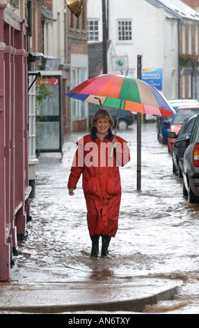 Woman walking through flooding in Tenbury Wells June 2007 Stock Photo