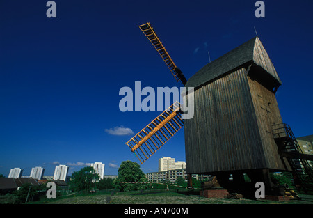 Berlin. Marzahn. Windmill on a hill in Alt-Marzahn with high-rise buildings of Marzahner Promenade in the background. Stock Photo