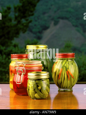 Jars of PICKLED PRODUCTS L TO R Serrano Peppers Turnips Beets Gherkins Jalapenos Green Beans Stock Photo