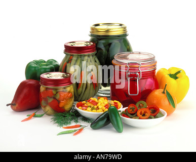 Jars of PICKLED PRODUCTS L TO R Serrano Peppers Green Beans Jalapenos Turnips Beets produce Stock Photo