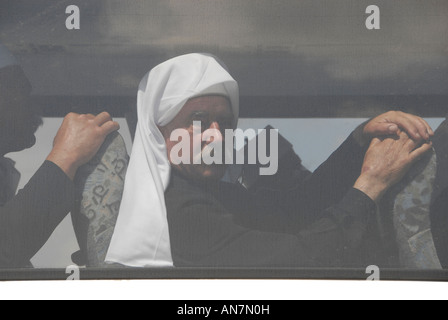 Members of the Druze community sit in a bus crossing the Israeli border into Syria, Golan Heights, Israel Stock Photo