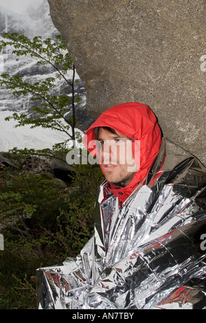 Male Wrapped in Survival Foil Blanket Stock Photo