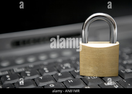 Padlock standing on a black laptop keyboard. Stock Photo