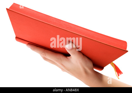 Female hand holding the holy book. Isolated on a white background. Stock Photo
