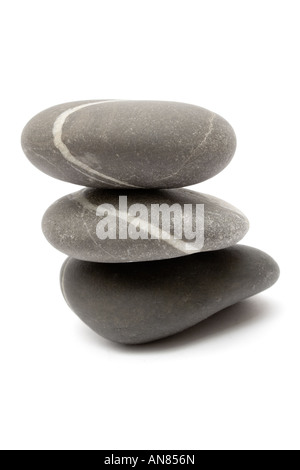 Three gray stones stacked on each other. Isolated on a white background. Stock Photo