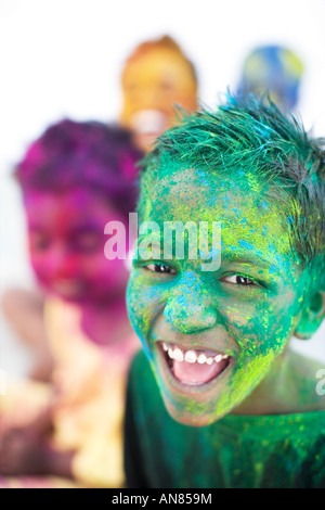 Young Indian boys covered in coloured powder pigment Stock Photo