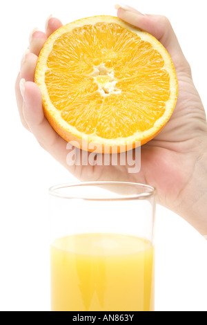 Pressing out an orange. Isolated on a white background. Stock Photo