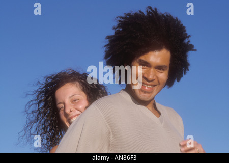 couple hugging 27 yr old Caucasian female and 34 yr mixed African Caucasian male Stock Photo