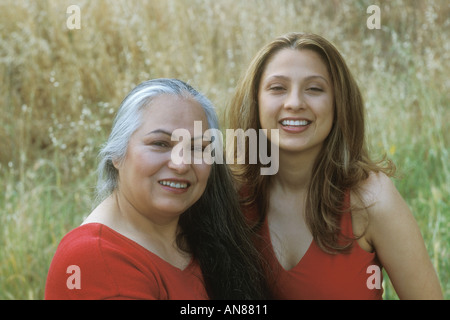 Portrait of 54 year old Hispanic female and 22 year old daughter in golden field Stock Photo