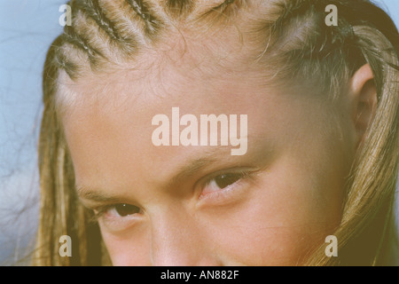 Tight portrait of 11 year old Mexican female with hair in cornrows Stock Photo