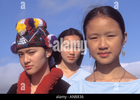 13 year old Asian in 'native clothes' between 2 10 to 13 year old Asian females in western clothes Stock Photo