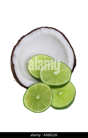 Half of a coconut with lime slices cut out on white background Stock Photo