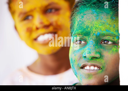 Young Indian boys covered in coloured powder pigment Stock Photo
