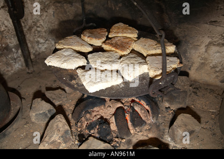 irish soda bread cooking on plate on traditional peat fire Stock Photo