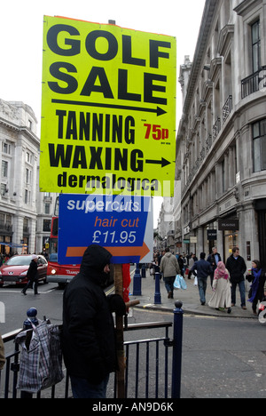 Christmas 2007 West End sales London Regent Street.Man carrying sandwich board  advertising tanning and waxing Stock Photo