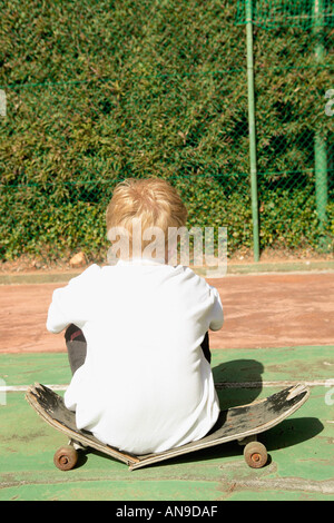 Boy on broken skateboard Stock Photo