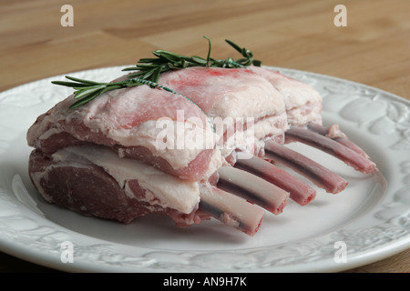 AN UNCOOKED RACK OF LAMB ON A PLATE. Stock Photo