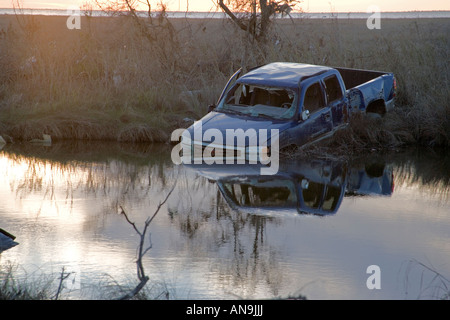 Damage  caused by Hurricane Katrina Near New Orleans Louisiana Blue truck stuck in flood waters Stock Photo