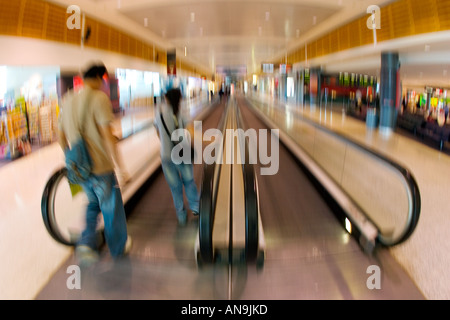 Commuters on an airport conveyor belt Australia Stock Photo