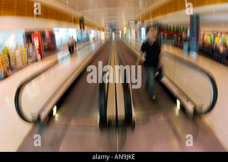 Commuter on an airport moving walkway Australia Stock Photo