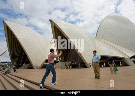 Tourists take photographs outside Sydney Opera House Australia Stock Photo