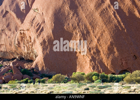 Tourists at the base of Ayers Rock Uluru Australia