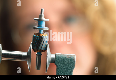 female engineer checking the measurement of a tool Stock Photo