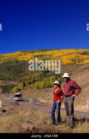 Couple in fall along highway in Fish Lake Mountains Utah USA. Stock Photo
