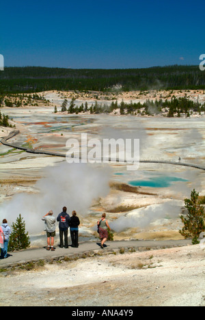Tourists Enjoying the View of the Porcelain Basin in Norris Geyser Basin from Overlook at Yellowstone National Park Wyoming USA Stock Photo