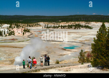 Tourists Enjoying the View of the Porcelain Basin in Norris Geyser Basin from Overlook at Yellowstone National Park Wyoming USA Stock Photo