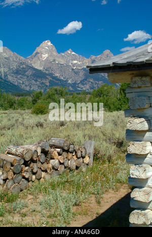 The Cathedral Group of Mountains with Corner of Old Cabin at Menors Ferry Grand Teton National Park Wyoming USA Stock Photo